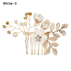Exquisite bridal hair comb with white flowers, pearls, and crystals on gold metal base