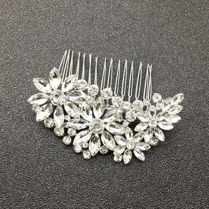 Detailed top view of silver bridal hair comb with marquise crystals and floral design