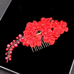 Detail of red handmade silk flower hair comb with pearls for bridal wedding accessories