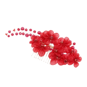 Detail of red bridal hair comb with handmade mesh flowers, pearls and crystals