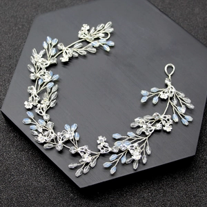 Elegant silver bridal headband featuring opal beads and shimmering rhinestones on black