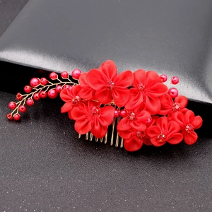 Macro detail of red fabric flower bridal hair comb with rhinestones and pearls
