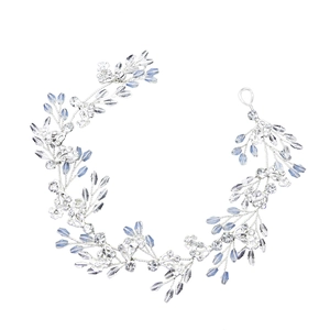 Handmade bridal hair vine with silver wire, blue leaf crystals, and clear beads on white background