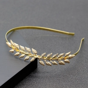 Elegant gold metal leaf laurel headband for women on a professional display stand