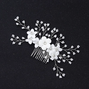 Elegant bridal hair comb with white fabric flowers and handmade pearls for weddings