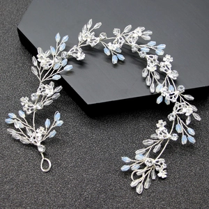 Exquisite bridal hair vine with sparkling crystals and opalescent beads on dark background