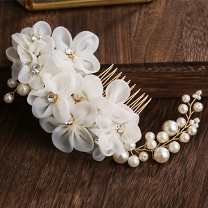 Exquisite bridal hair comb featuring white organza flowers and golden pearl sprigs