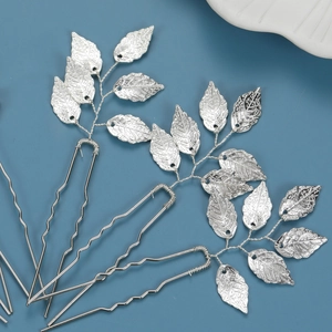 Three-piece set of U-shaped silver bridal hair pins with detailed metallic leaf designs