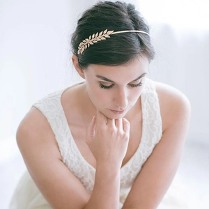 Golden laurel leaf headband on model featuring Greek revival style and metal olive branches