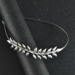Close-up of elegant silver alloy leaf headband with detailed vein textures on black display