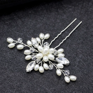 Detail of bridal hair pin featuring white pearls and marquise crystals on silver wire