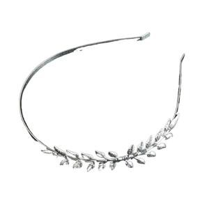 Detailed macro view of silver metallic leaf patterns and vein textures on a bridal headband