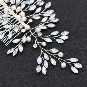Bridal hair comb with silver vines, pearls, and rhinestones on dark background