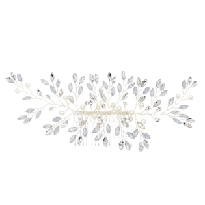 Detail of silver bridal hair comb featuring blue crystals and white pearls in leaf design