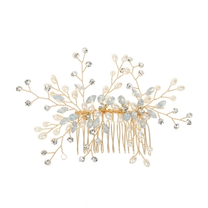 Detail of handcrafted bridal hair comb with pearls and blue marquise stones on gold wire