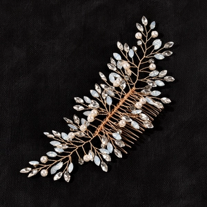 Detailed view of handcrafted bridal hair comb with gold wires, pearls and crystals