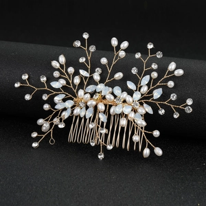Detail of handcrafted wedding hair comb with white pearls and sparkling marquise crystals