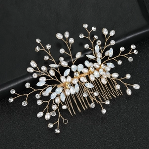 Detail of handcrafted gold bridal hair comb with pearls and marquise stones