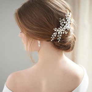 Detailed back view of a bride wearing a silver bridal hair comb with pearls and crystals