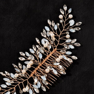 Detailed macro of handmade golden bridal hair comb with pearls and marquise crystals