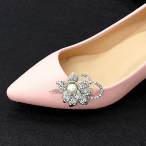 Elegant silver flower shoe clip with rhinestones and pearl on a pink high heel shoe