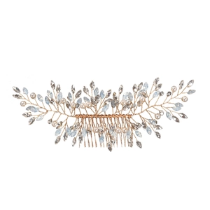 Macro detail of gold bridal hair comb with pearls and light blue crystal leaf designs