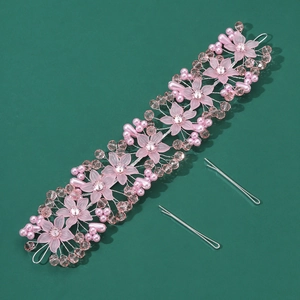 Detail of handmade pink crystal flower headband and pearl hair clips set for wedding