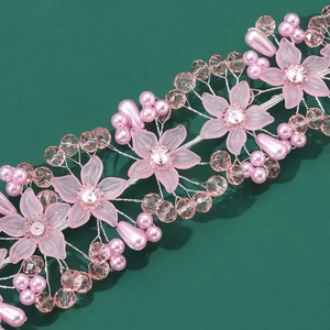 Detailed macro of handmade pink acrylic flower bridal headband with pearls and crystal beads