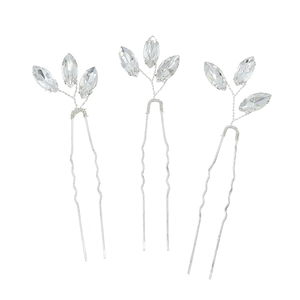 Close-up of three U-shaped silver hair pins with marquise-cut crystals for wedding