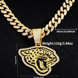 Close-up of golden leopard head pendant with rhinestones and Cuban link necklace details