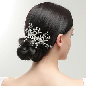 Handmade bridal hair comb with pearls, crystals and opals on elegant low bun hairstyle