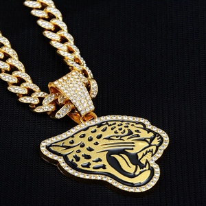 Hip-hop style gold panther pendant with white rhinestones on a heavy Cuban link chain