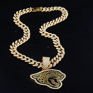Detailed close-up of iced-out gold panther pendant necklace with sparkling white crystals