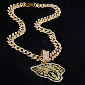 Detailed close-up of golden hip hop chain with iced-out jaguar head pendant and white stones