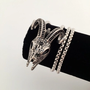 Detailed macro view of vintage ram skull bracelet with antique silver finish and square chain