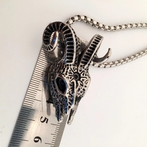 Macro view of vintage silver goat skull pendant with ruler showing size 4cm