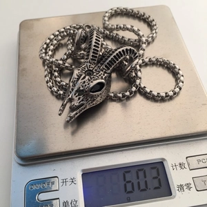 Gothic goat head skull pendant necklace on digital scale showing weight of 60.3g