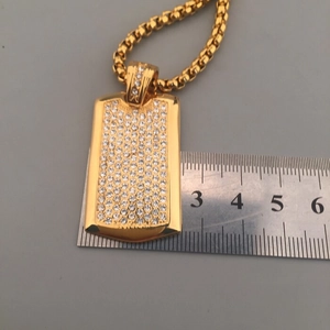 Close-up of hip hop gold plated military tag necklace with sparkling pave diamonds