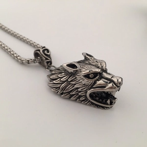 Detailed macro view of retro stainless steel wolf head pendant with oxidized textures