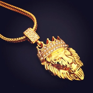 Detailed close-up of a golden hip-hop lion head pendant with sparkling crown and stones