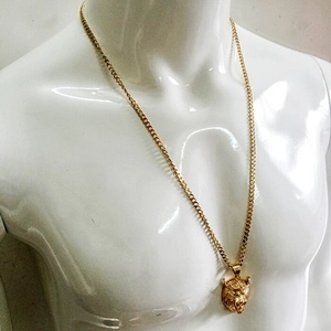 Detailed view of hip-hop gold lion head pendant with crown on model display