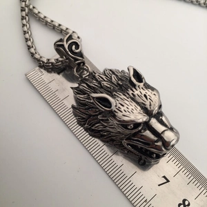 Detailed size measurement of a silver wolf head pendant necklace with vintage relief