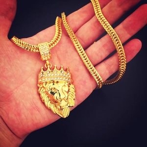 Close-up of hip hop lion head pendant with a diamond crown on a thick gold chain