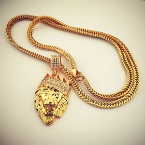 Close-up of hip hop lion head pendant with gold crown and shimmering zircon accents