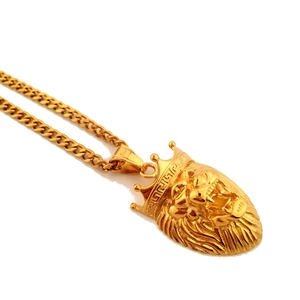 Close-up detail of golden lion head pendant with crown and Cuban link chain
