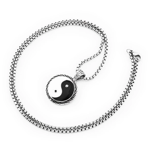 Detailed close-up of Yin Yang Tai Chi pendant with vintage braided edge on silver chain