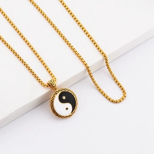 Close-up of Tai Chi Yin Yang pendant necklace with gold frame and box chain