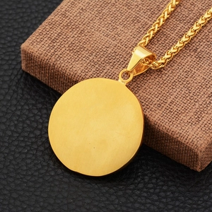 Close-up of golden round star pendant with wheat chain on premium display box