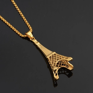 Golden Eiffel Tower pendant necklace with round box chain on reflective black background
