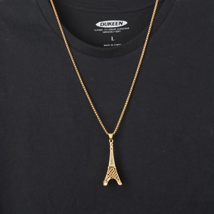 Close-up of golden Eiffel Tower pendant with detailed hollow design on long steel chain